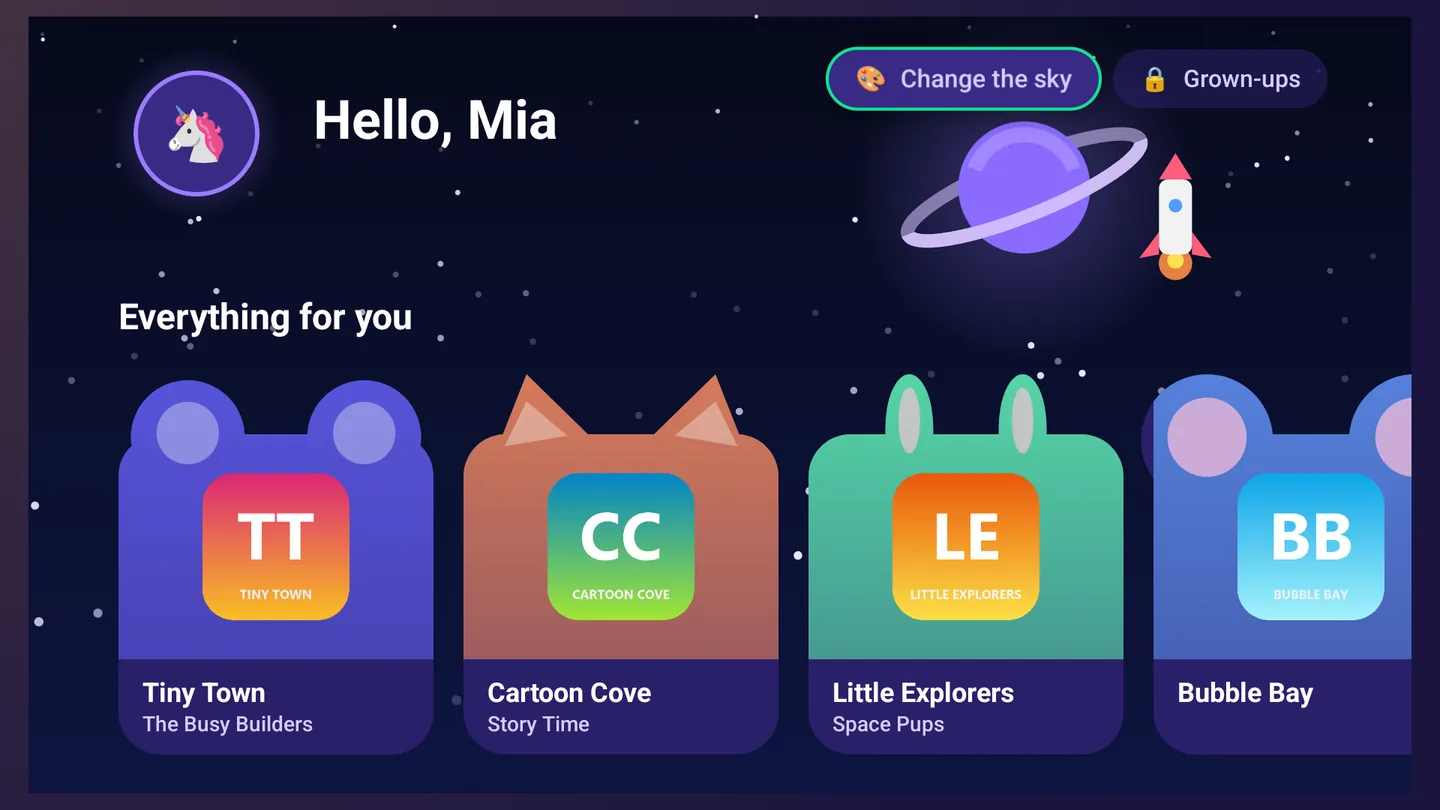 The kids home screen on the Space sky, a ringed planet and a rocket: Hello, Mia, and the channels as animal-shaped cards with each channel's logo for a face.